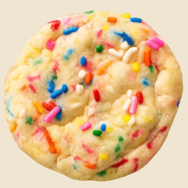 Cookie with colorful sprinkles on a beige background